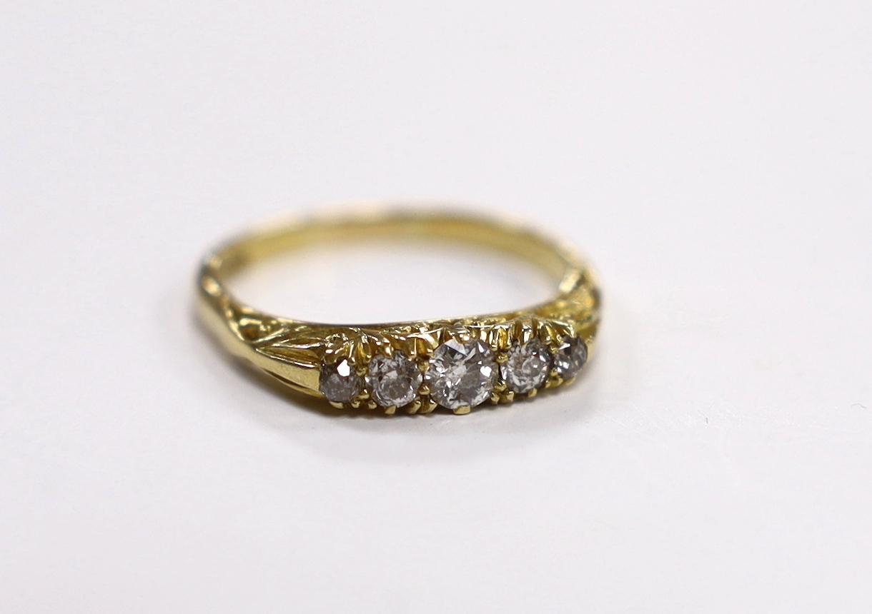 An 18ct and graduated five stone diamond set half hoop ring, size P/Q, gross weight 3.7 grams.